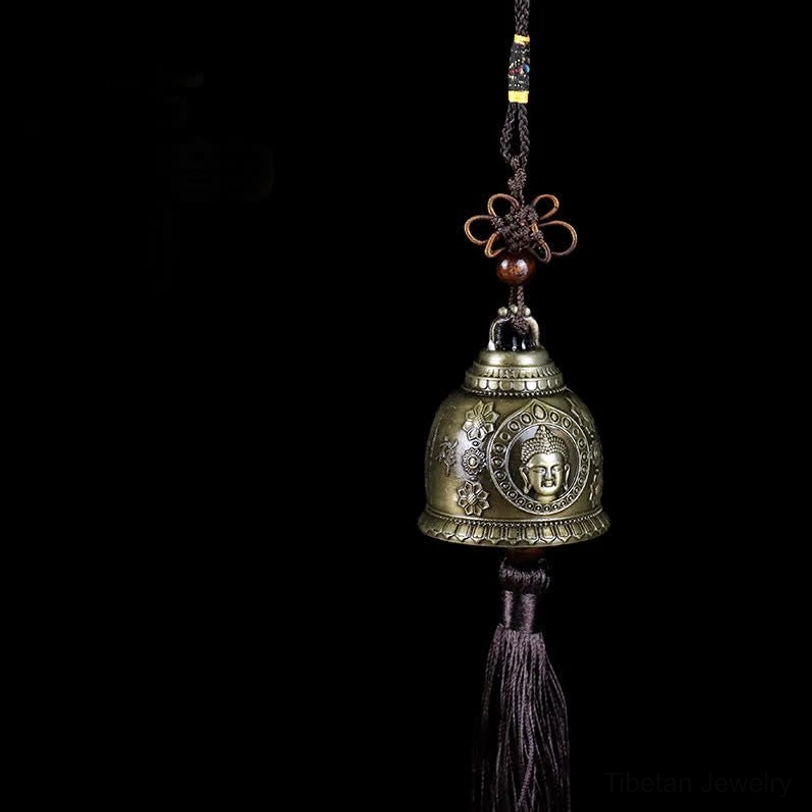 Tibetan Buddha face wind chime bell with bronze finish and brown tassel, handcrafted zinc alloy spiritual decoration