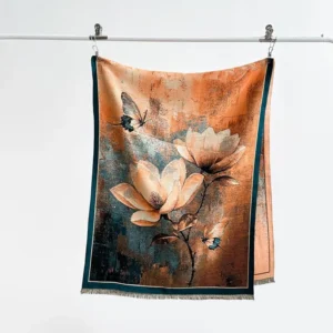 Tibetan magnolia butterfly scarf flat lay display, showing retro orange and blue floral print with dark green fringed border