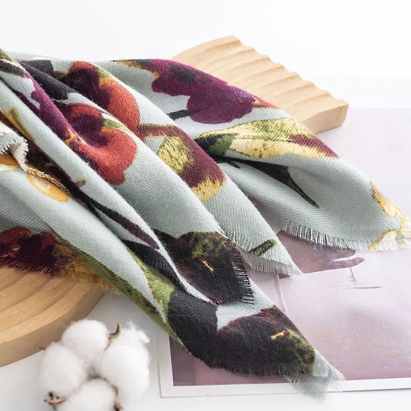 Folded Tibetan butterfly flower shawl on home decor setting with raw frayed edges visible