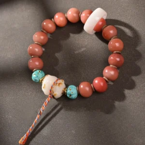 Handmade Tibetan camel bone bracelet with white bone ring, turquoise bead, and carved bone pendant