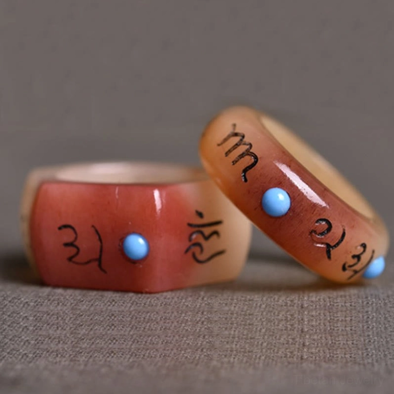 Two camel bone Tibetan protection rings in different styles displayed together, showing round and hexagon design variations