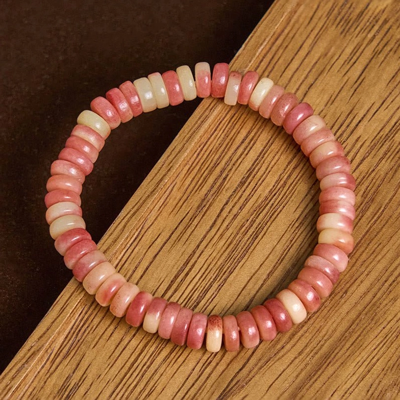 Two-tone Tibetan camel bone bracelet with mixed pink and beige disc beads showing natural bone color variation