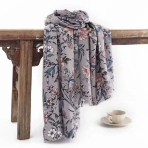 Tibetan camellia floral scarf with vintage blooming flower print, dusk grey retro wrap draped over vintage wooden table with coffee set styling