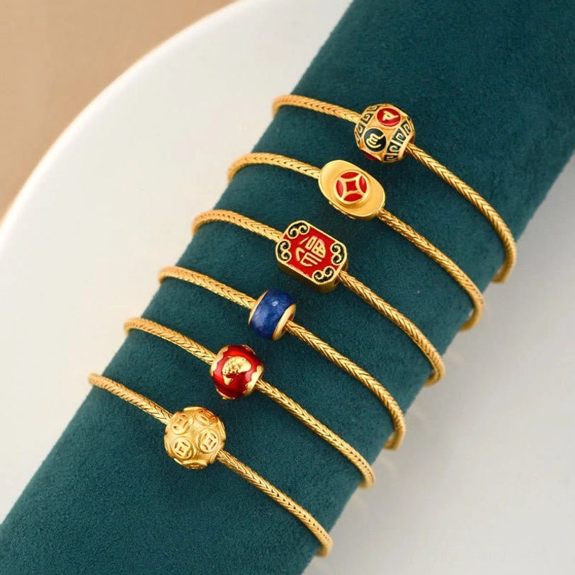 Collection of Tibetan Buddhist charm bracelets featuring Fu character, Koi fish, and lucky symbols in gold