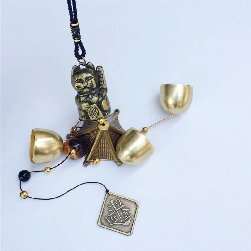 Disassembled Lucky Cat Wind Chime components brass bells beaded cord fortune tag flat lay