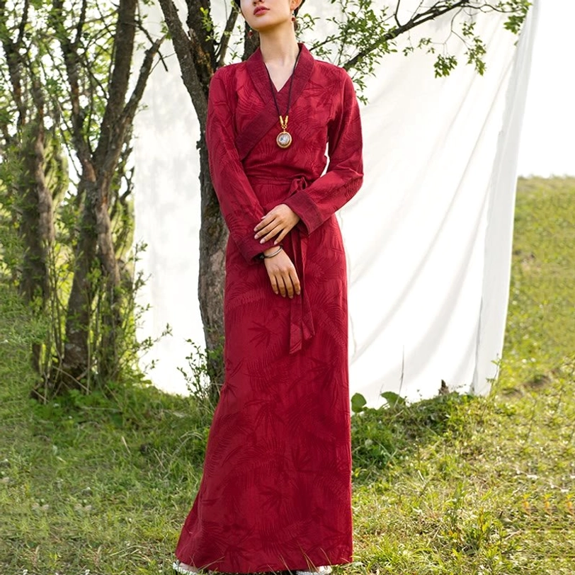 Tibetan wrap maxi dress in burgundy with bamboo leaves pattern, full-body model view showing wrap design and waist sash