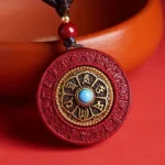 Rotatable Cinnabar Om Mani Padme Hum Buddhist Pendant - Top View with Turquoise Center Stone and Gold Engraved Border