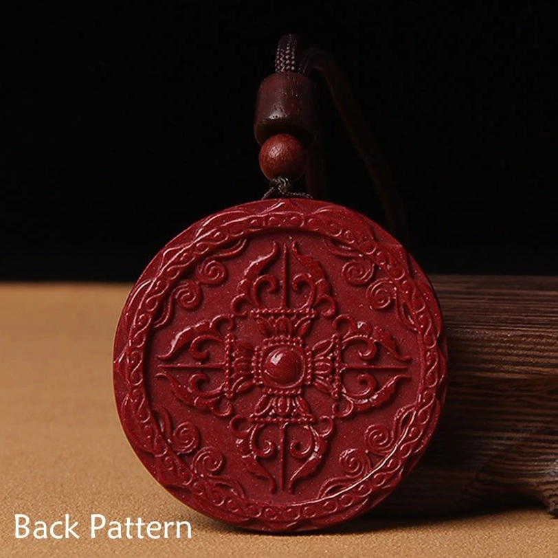 Intricate back side of Tibetan cinnabar blessing pendant featuring Vajra protection symbol and traditional Buddhist carving