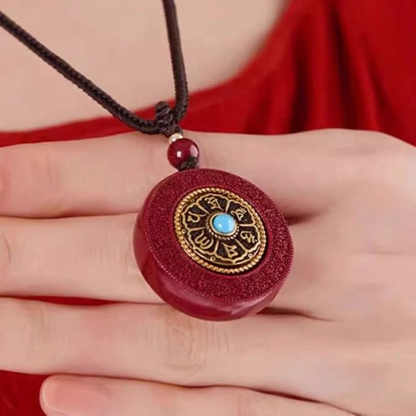 Handcrafted Cinnabar Tibetan Pendant - Side Angle View Showing Deep Red Stone and Gold Trim Details