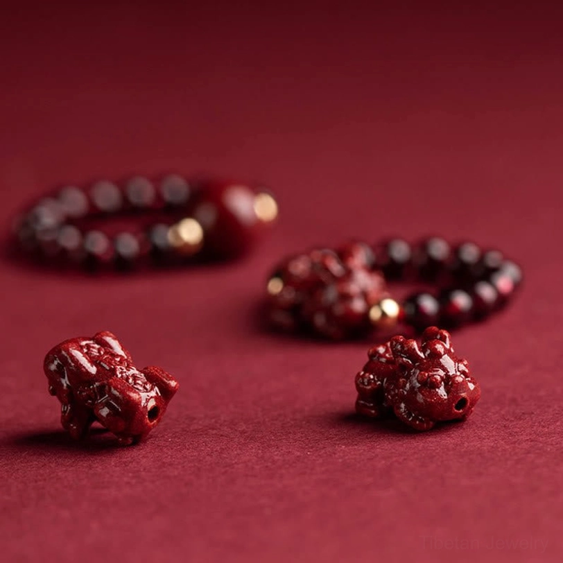 Tibetan protection ring featuring cinnabar beads, PiXiu charm, and precious metal findings for spiritual practice and daily wear