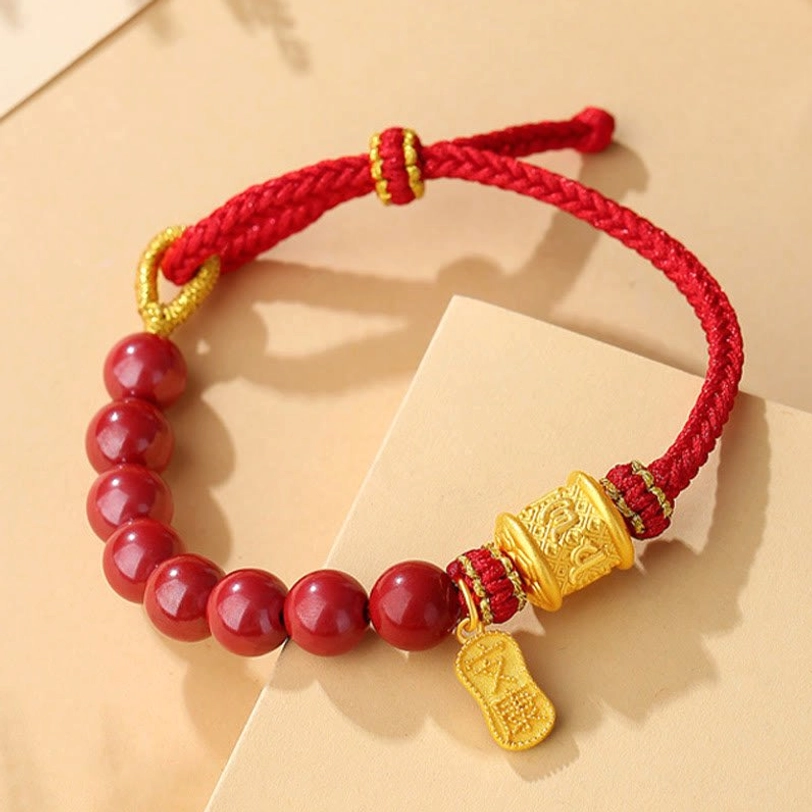 Six true words mantra red string blessing bracelet with adjustable knot and silver charm displayed on cardboard background