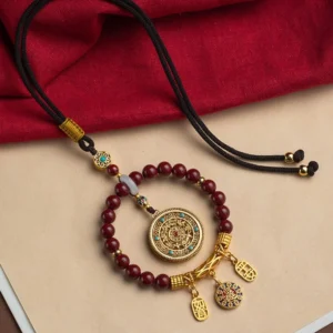 Complete tibetan blessing car decoration set laid flat displaying cinnabar beads adjustable hanging cord and gold lucky charms