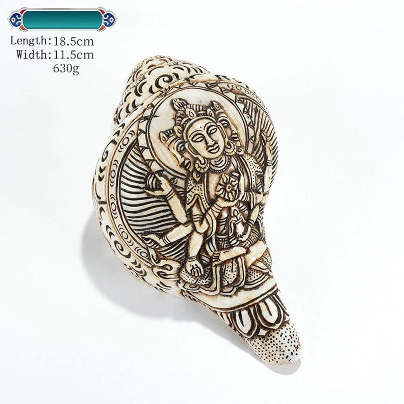 Authentic Tibetan engraved conch shell featuring sacred deity carving traditional Himalayan artisan craftsmanship