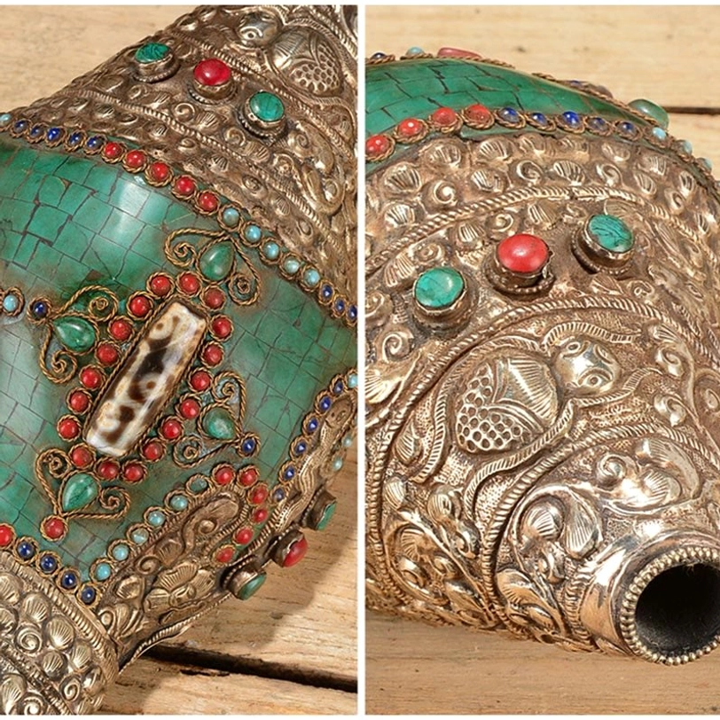 Tibetan conch shell ornament macro close-up on light background displaying turquoise tile inlay, red and blue gemstone borders, and silver carvings