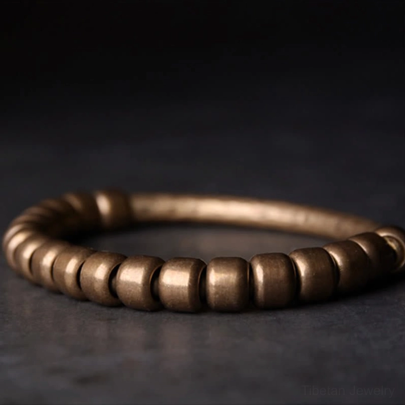 Authentic Tibetan-inspired copper beaded bracelet showcasing spiritual prosperity symbolism and artisanal handcrafted quality