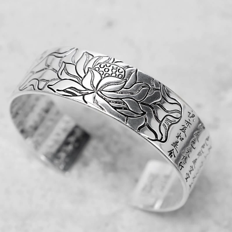 Tibetan copper lotus bracelet side profile view displaying silver-toned metal finish and intricate lotus engraving