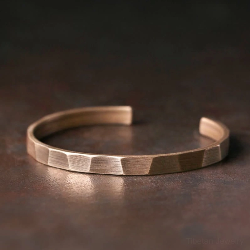 Tibetan copper wealth bracelet polished faceted edges adjustable open cuff top-down view