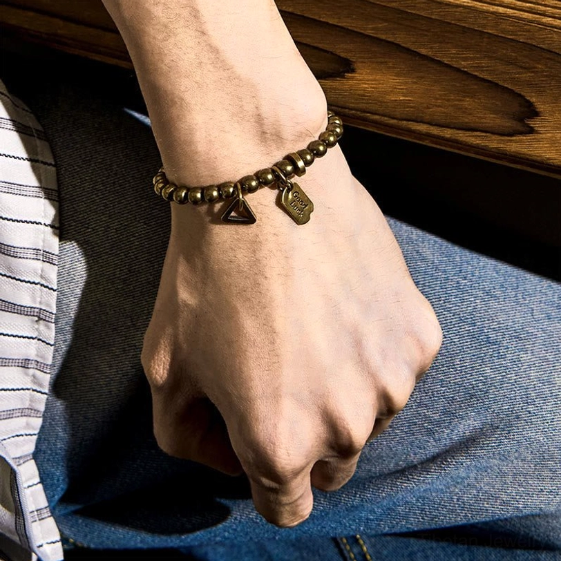 Tibetan copper luck bracelet multiple size options displayed showing elastic band construction and bead variety