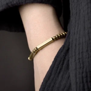 Copper wealth bracelet worn on wrist close-up side view minimalist design