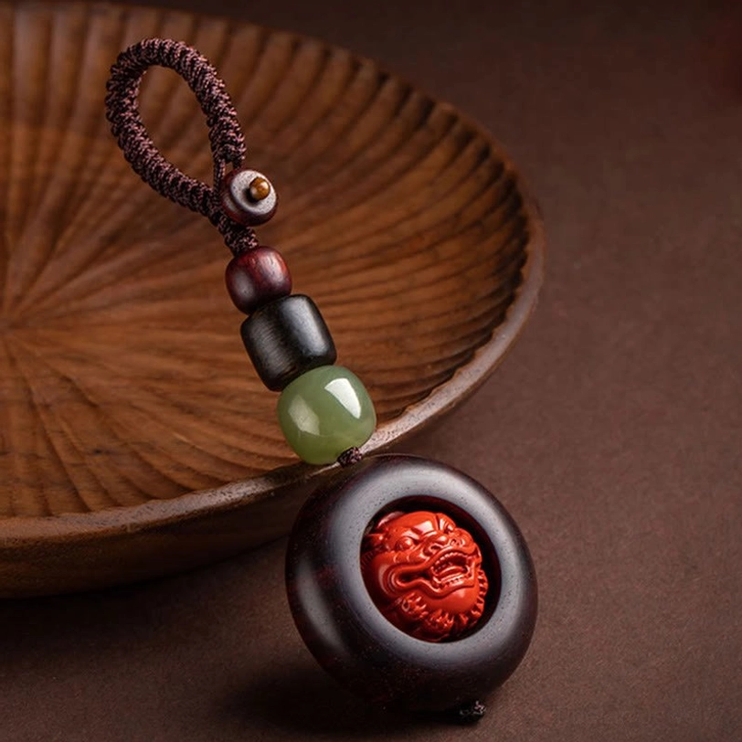 Copper coin keychain detail showing authentic Tibetan design and red sandalwood materials