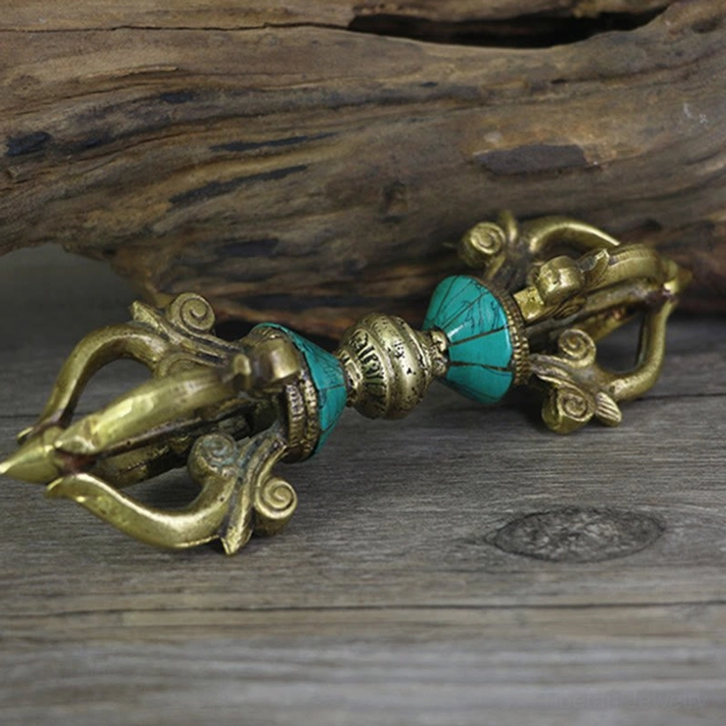 Flat lay photography of handcrafted copper five-prong dorje on wooden table with aged brass finish