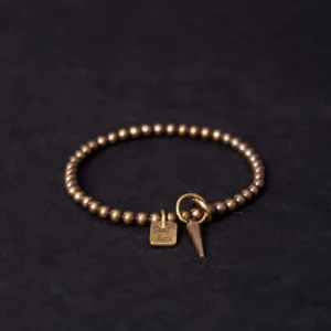 Tibetan copper prosperity bracelet with good luck charm flat lay top view featuring antique bronze beads and engraved square pendant
