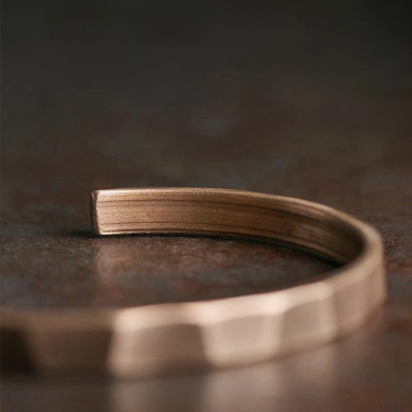 Tibetan copper prosperity bracelet adjustable cuff detail shot showing metalwork craftsmanship and patina