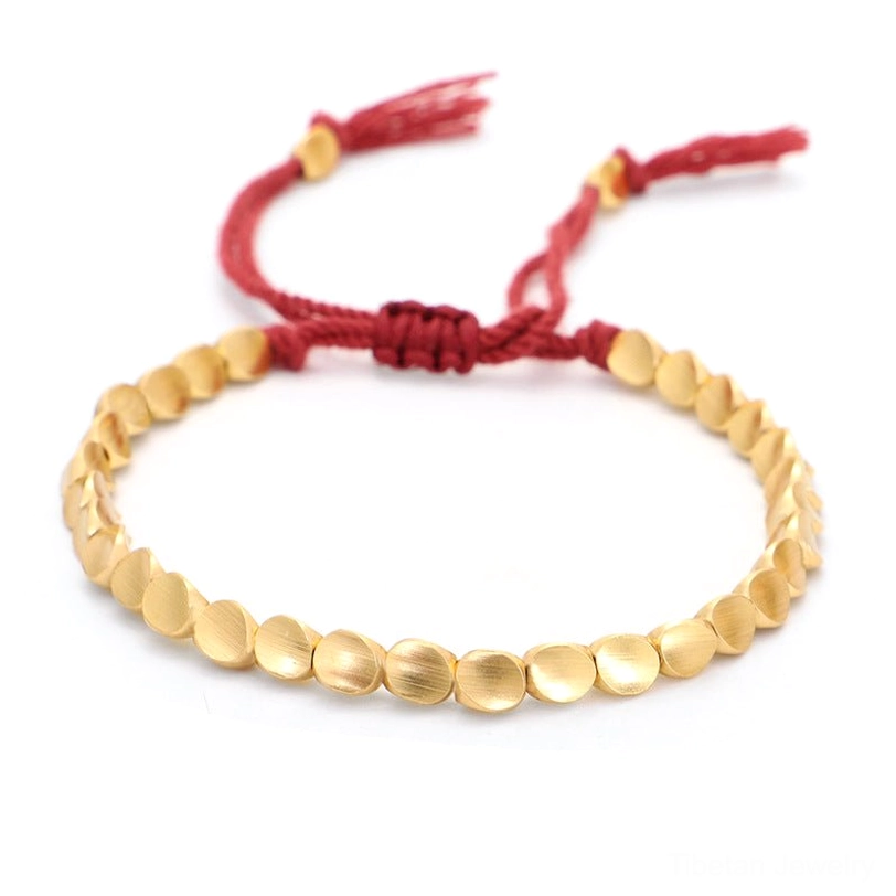 Solid red woven Tibetan copper bracelet with matte gold flat round beads and red fixing knot