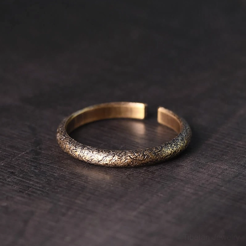 Tibetan vintage copper ring 2mm band overhead view - top down showing inner band etched surface and rough finish on wood grain