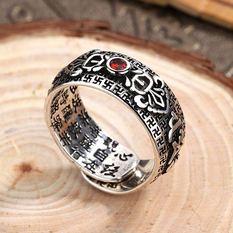 Tibetan silver copper ring oblique top view showing inner wall Buddhist scriptures red gem and detailed vintage engravings