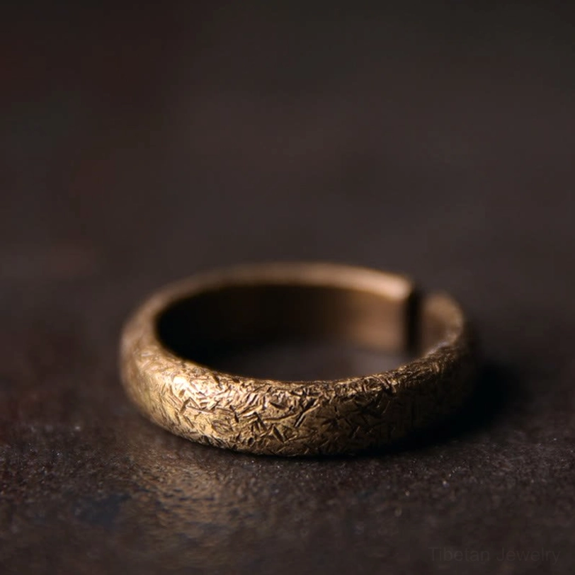 Tibetan vintage textured copper ring front view - three quarter close-up displaying full textured band and adjustable open ends