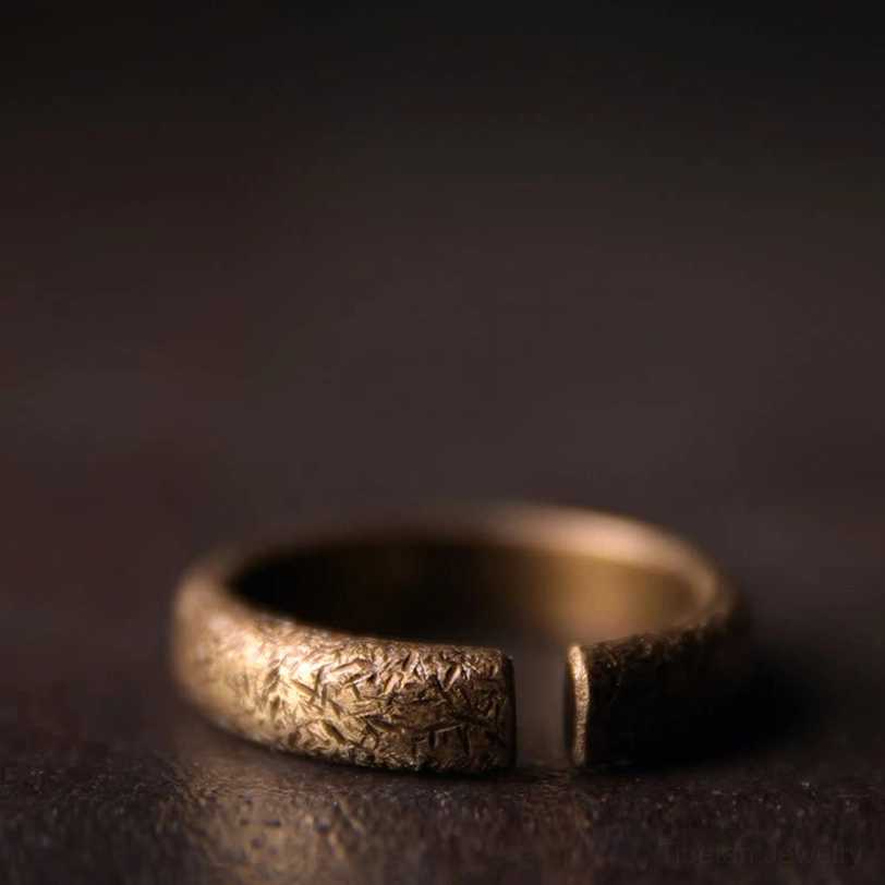 Single Tibetan vintage copper ring reverse angle - side close-up showing adjustable open gap and distressed bronze texture detail