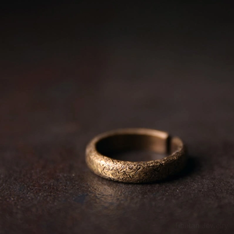 Single Tibetan vintage textured copper ring - three quarter side close-up highlighting uniform distressed bronze grain and craftsmanship