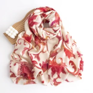 Overhead flat lay of red damask floral wrap with wooden hair accessory styling prop