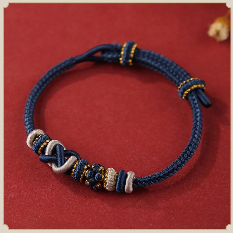 Dark blue handwoven tibetan peace knot bracelet with gold accents and braided decorative knot, spiritual blessing charm