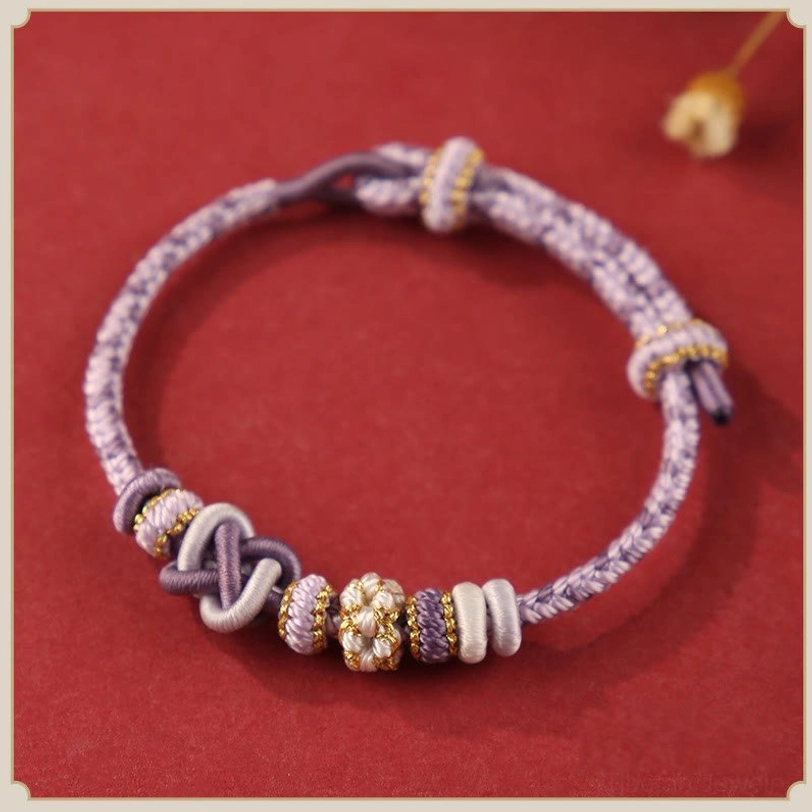Dark purple tibetan blessing bracelet with sacred peace knot design, spiritual protection and inner wisdom symbol