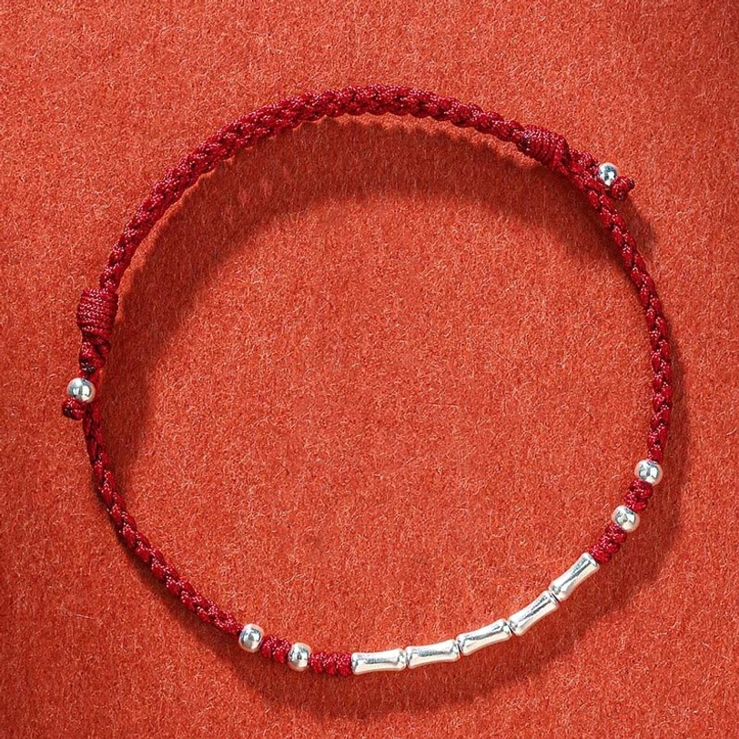 Dark red Tibetan handmade braided protection bracelet with deep crimson threads and silver metal bead accents