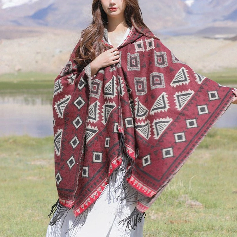 Dark red Tibetan hooded poncho with ethnic geometric tribal design and tassel trim details
