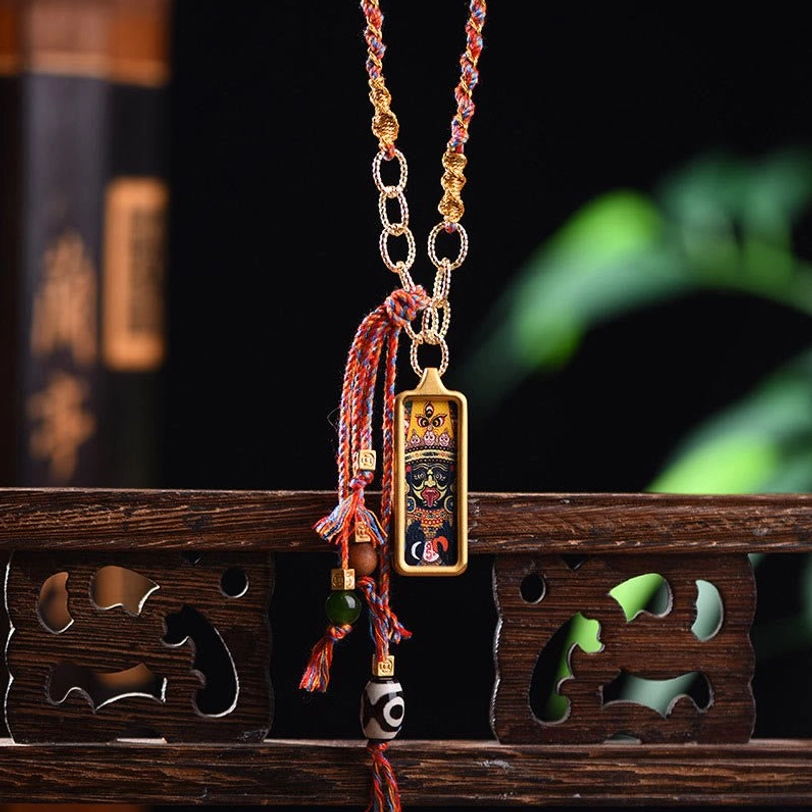 Tibetan deity portrait titanium steel necklace with red-brown woven lanyard and beads oblique view