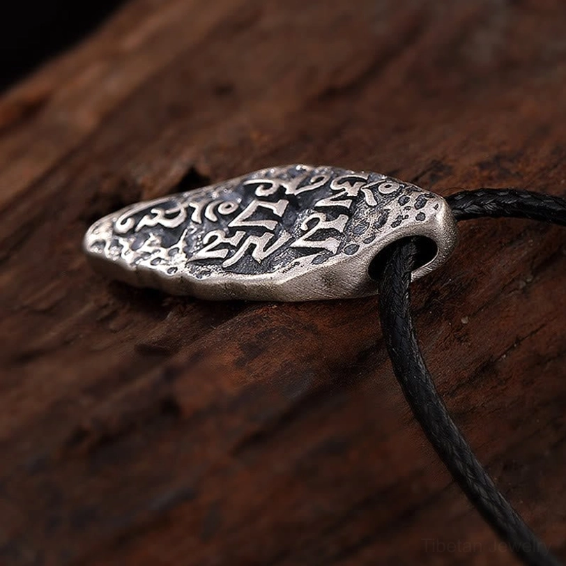 Tibetan silver Dorje pendant with black wax cord, right-bottom angle view showing side profile of handcrafted pendant