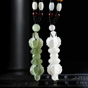 Pair of Hetian Jade Dorje Vajra pendants in cyan and white, frontal view with matching braided cords and spacer beads