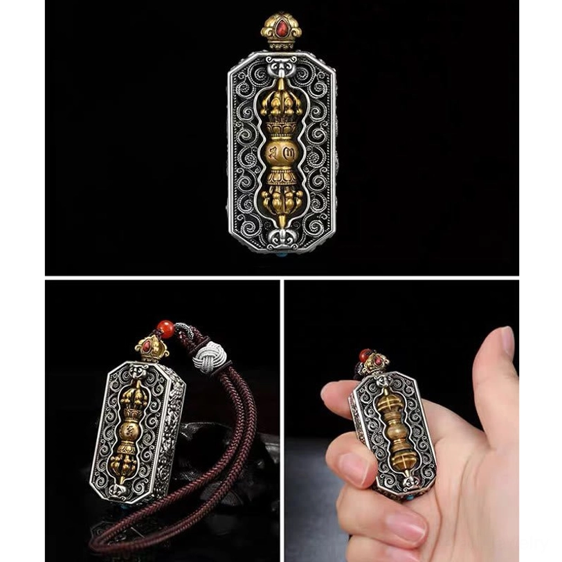 Front static shot of Tibetan dorje vajra pendant necklace with brown braided rope and silver filigree frame showing rotatable golden vajra