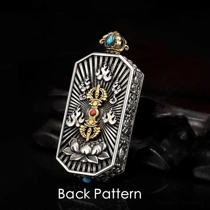 Back view of Tibetan vajra pendant showing radial lotus base design pattern with blue and red gemstone inlays on black background