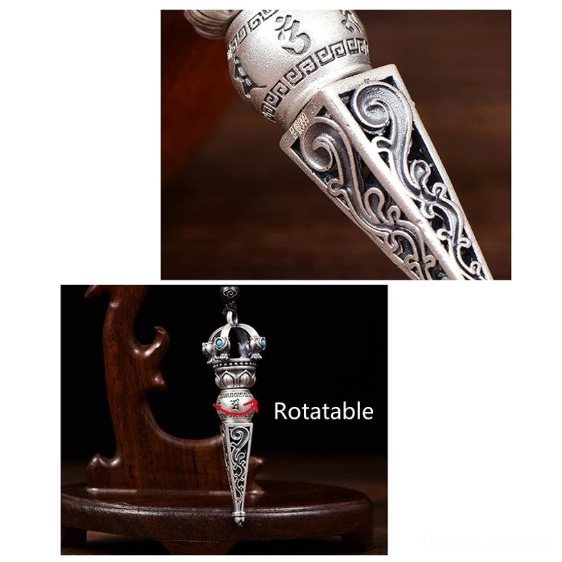 Side oblique view of Tibetan Dorje Vajra pendant on carved wooden display stand highlighting slim profile, scroll engravings, and turquoise accents