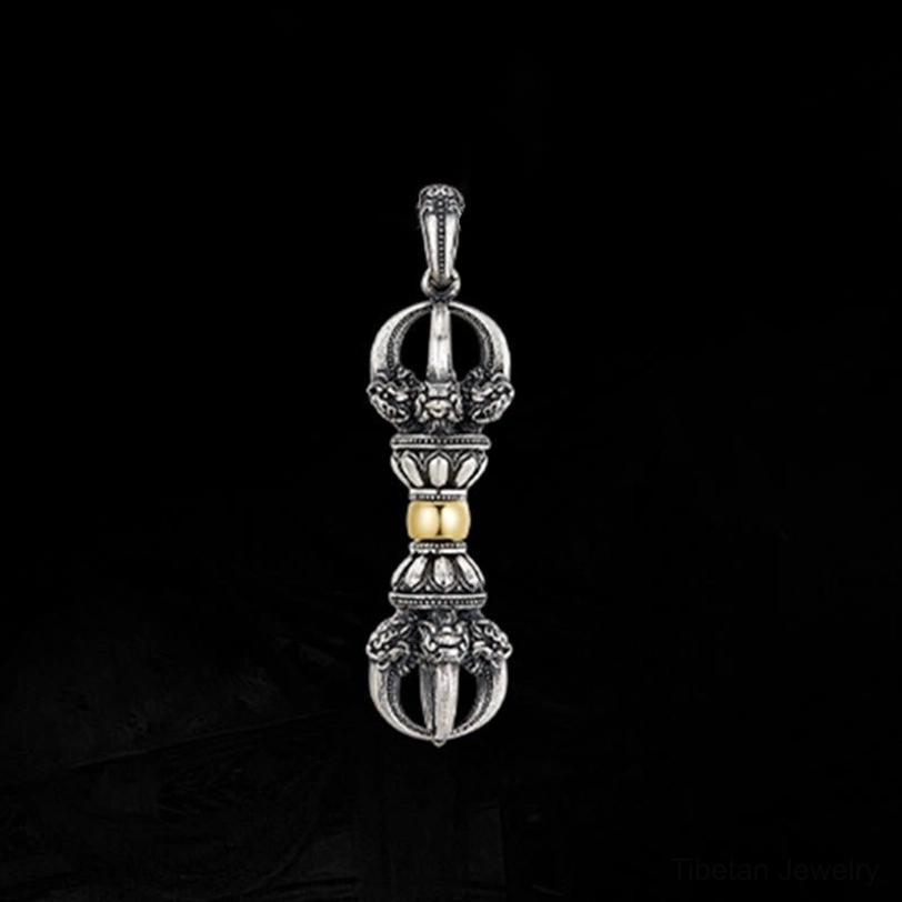 Tibetan Dorje Vajra pendant without chain on black background, front view showing intricate hand-carved details and two-tone silver-gold finish