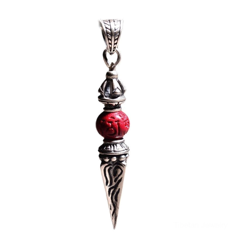 Tibetan dorje vajra pendant standalone front view showing full carved tip design and cinnabar stone integration