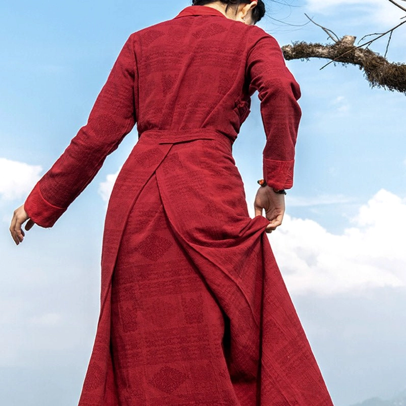 Back view of Tibetan chuba maxi dress showing long sleeves, rear waist tie, and flowing floor-length skirt with natural textile texture