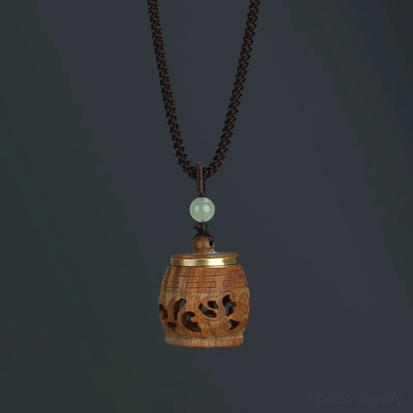 Warm-toned rosewood Tibetan drum pendant necklace alternative, traditional dharma teaching instrument representation