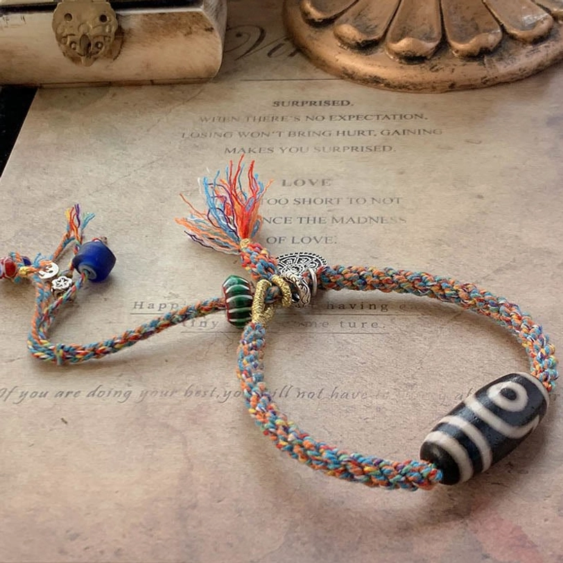 Blue Tibetan Dzi bead bracelet featuring black-white patterned bead, silver ornaments and blue accent beads