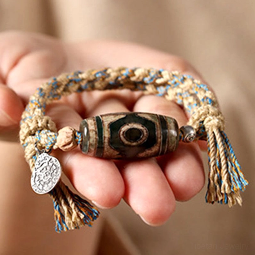 Authentic Tibetan Dzi bead bracelet showcasing hand-painted sacred stone patterns and traditional artisan craftsmanship